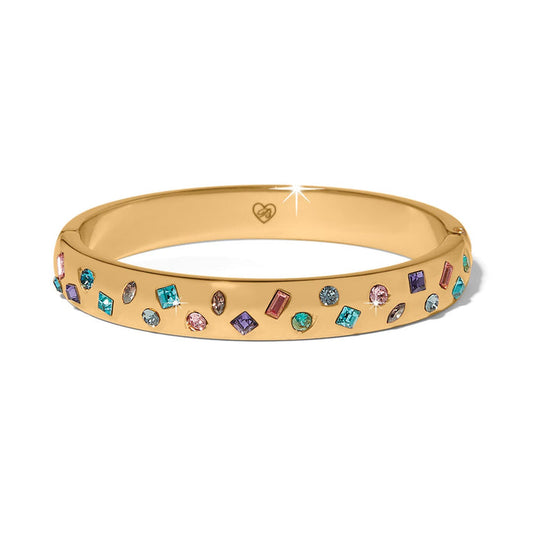 Brighton gold-plated bangle bracelet with scattered multicolored crystals in various shapes and sizes on a white background