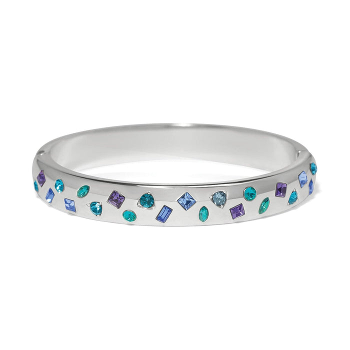 Brighton silver-plated bangle bracelet with scattered blue, purple, and teal crystals in mixed shapes on a white background