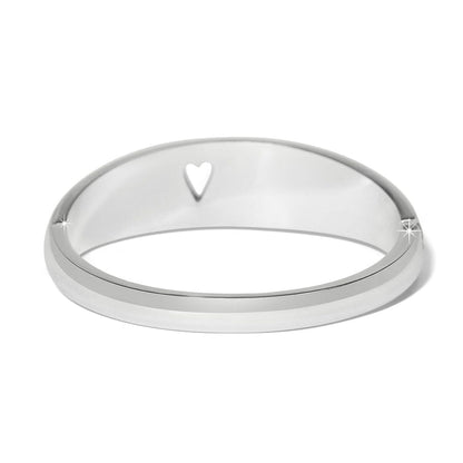 Brighton silver-plated bangle bracelet with cut-out heart detail and polished finish on a white background