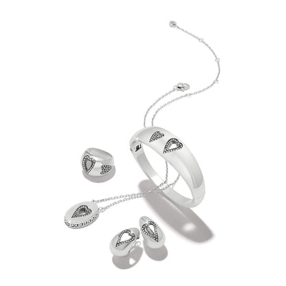 Brighton silver-plated jewelry set styled with bangle, ring, pendant necklace, and earrings featuring crystal heart accents