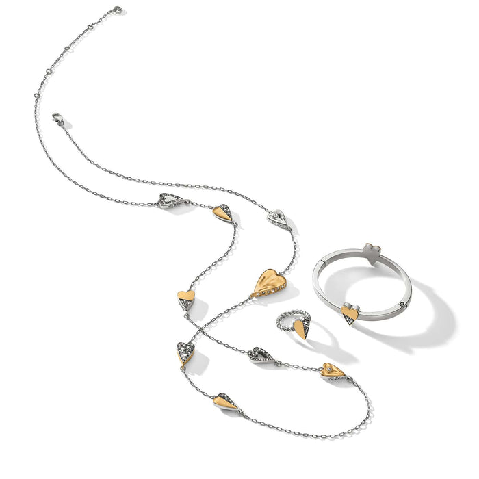 Brighton two-tone hinged bangle bracelet with gold heart accents and crystal pavé detail on a white background