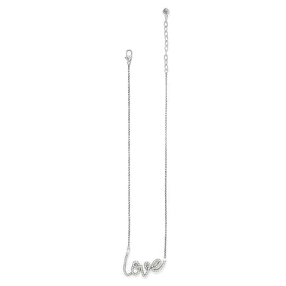Brighton silver-plated necklace with cursive love script pendant accented with crystals and lobster clasp on a white background