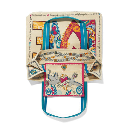 Brighton canvas tote bag shown open with LOVE print, dove interior pocket, and blue straps on a white background
