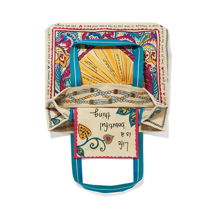 Brighton canvas tote bag shown open with paisley print, Life is a beautiful thing text, and teal handles on a white background
