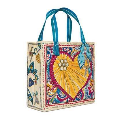 Brighton tote handbag with heart rope print, love phrases, paisley details, and blue handles on a white background