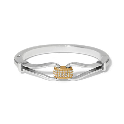 Brighton bangle bracelet with silver-plated curved band and gold-plated center station with crystal pavé on a white background