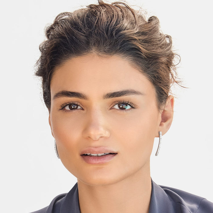 Model wearing Brighton linear drop earrings with silver-plated finish and pavé crystal accents along slim bars