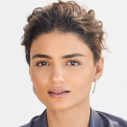 Model wearing Brighton linear drop earrings with silver-plated finish and pavé crystal accents along slim bars