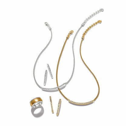 Brighton jewelry styled with matching silver and gold plated necklaces, crystal bar earrings, and a ring