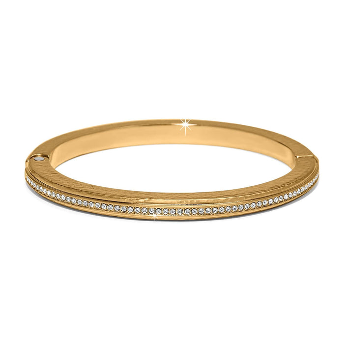 Brighton gold-plated bangle bracelet with hammered texture and a row of crystals on a white background