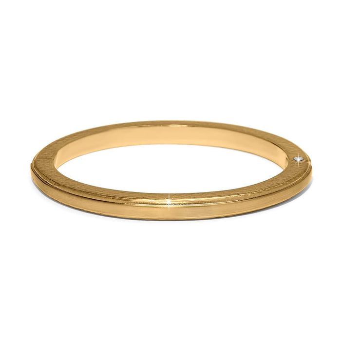 Brighton gold-plated bangle bracelet with smooth polished finish and slim grooved edge detail on a white background