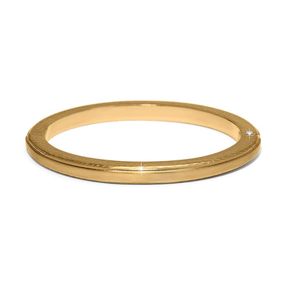 Brighton gold-plated bangle bracelet with smooth polished finish and slim grooved edge detail on a white background