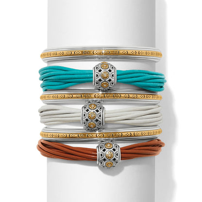 Brighton bracelet stack with two-tone bangles and turquoise, white, and brown leather cord designs on a white background