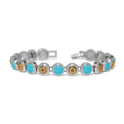 Brighton bracelet with turquoise cabochons and gold-tone medallion links in two-tone finish on a white background
