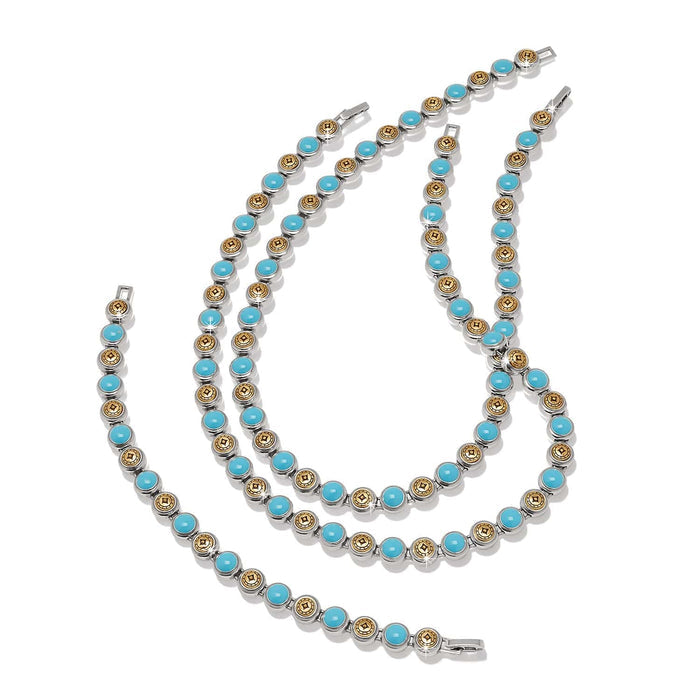 Brighton necklace and bracelet set with turquoise beads and two-tone medallion stations on a white background