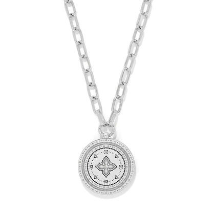 Brighton pendant necklace with silver-tone medallion featuring engraved floral motif and crystal center on a white background