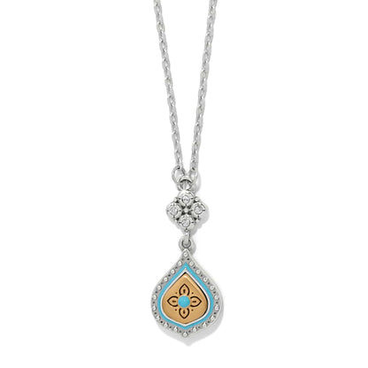 Brighton pendant necklace with two-tone teardrop, turquoise enamel, gold floral center, and crystal accents on a white background