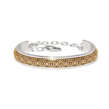 Brighton cuff bracelet with two-tone finish, gold star pattern center band, and silver chain closure on a white background