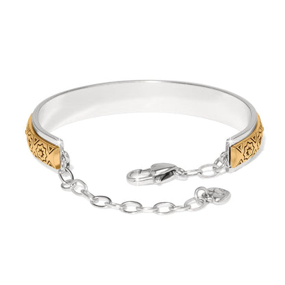 Brighton bangle bracelet with two-tone finish, engraved gold star motifs, and silver-tone chain clasp on a white background