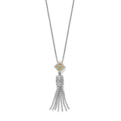 Brighton tassel pendant necklace with two-tone floral medallion, turquoise crystal accents, and silver-tone beaded tassel on a white background