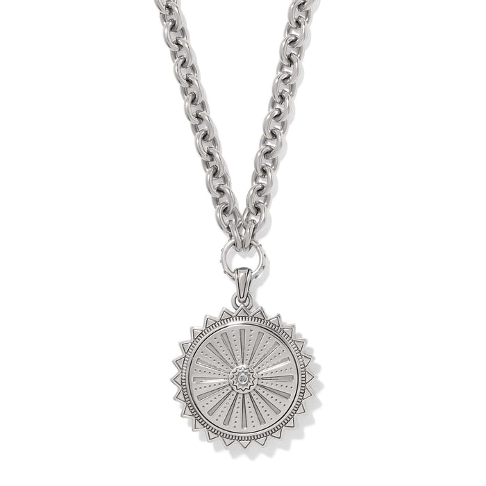 Brighton pendant necklace with silver-tone sunburst medallion, crystal center, and chunky cable chain on a white background