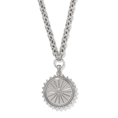 Brighton pendant necklace with silver-tone sunburst medallion, crystal center, and chunky cable chain on a white background