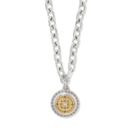 Brighton pendant necklace with two-tone medallion, gold patterned center, crystal accent, and silver chain on a white background