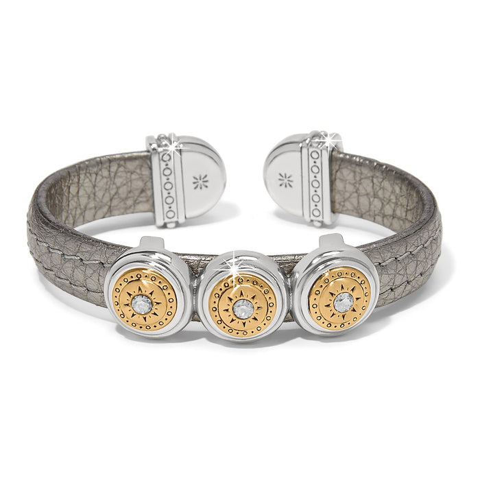 Brighton cuff bracelet with pewter leather band and three two-tone medallions with crystal centers on a white background
