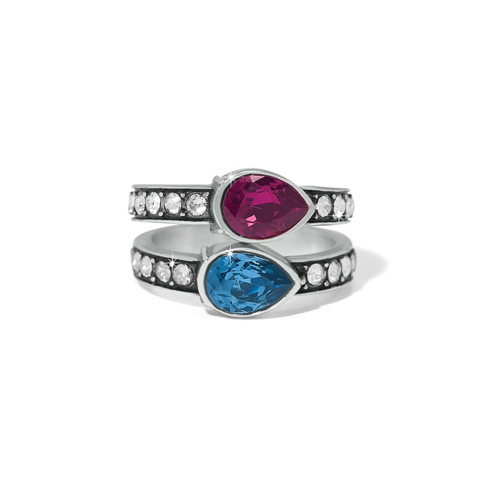 Brighton silver-plated rings with pink and blue pear-shaped crystals and pavé crystal bands on a white background