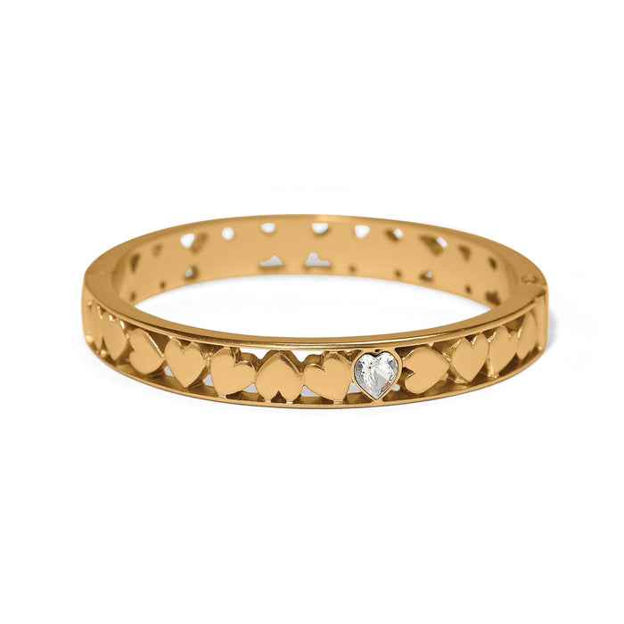 Brighton hinged bangle bracelet with gold-plated heart cutout design and crystal heart accent on a white background