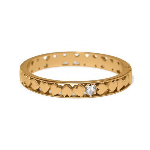 Brighton hinged bangle bracelet with gold-plated heart cutout design and crystal heart accent on a white background