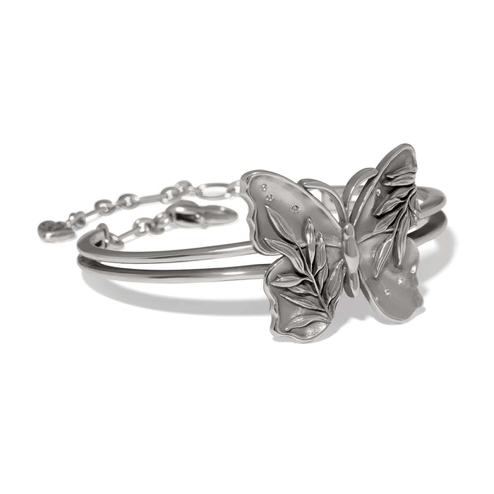 Brighton hinged bangle bracelet with silver-tone butterfly centerpiece featuring leaf detailing and crystal accents on a white background