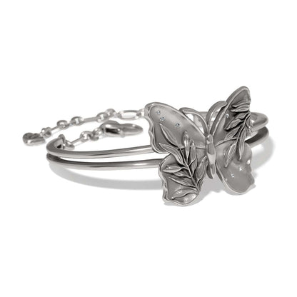 Brighton hinged bangle bracelet with silver-tone butterfly centerpiece featuring leaf detailing and crystal accents on a white background