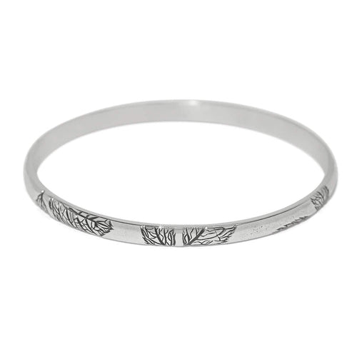 Brighton bangle bracelet with silver-plated finish and engraved tree branch design along the band on a white background