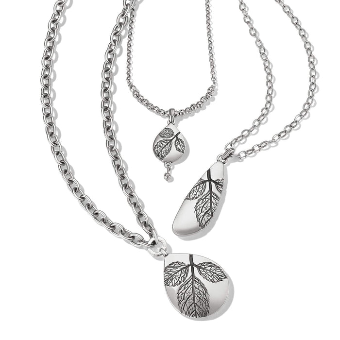 Brighton layered necklace with three silver-plated chains and teardrop pendants featuring engraved leaf designs on a white background