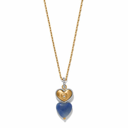 Brighton pendant necklace with two-tone heart charm, blue stone heart drop, and crystal accents on a white background