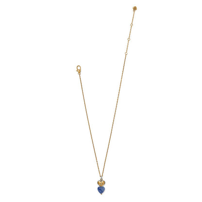 Brighton pendant necklace with two-tone heart charm, blue stone heart drop, and crystal accents on a white background