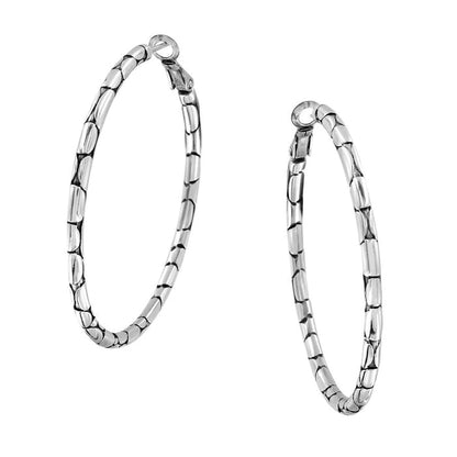 A pair of Pebble Large Hoop Earrings in silver with a bamboo design on a white background.