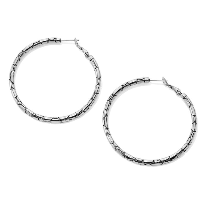 Pebble Large Hoop Earrings side view, silver hoop earrings with a bamboo-style design rest against a white background.