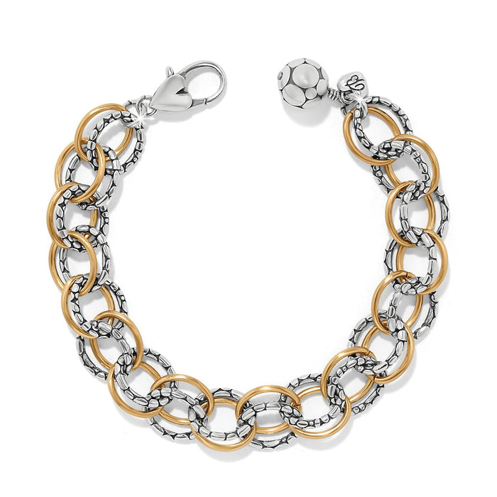 Brighton link bracelet with two-tone silver textured and gold smooth rings, lobster clasp, and bead charm on a white background