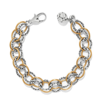 Brighton link bracelet with two-tone silver textured and gold smooth rings, lobster clasp, and bead charm on a white background
