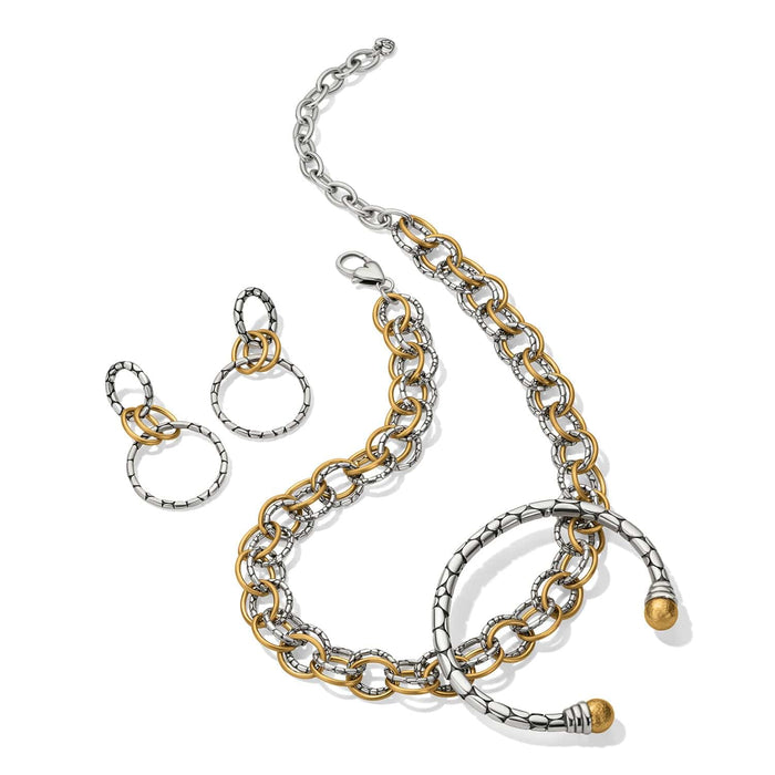 Brighton two-tone jewelry set styled with linked chain necklace, drop earrings, and bangle bracelet on white background