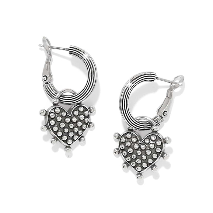 Brighton hoop earrings with silver-plated ribbed hoops and dotted heart charms with beaded edges on a white background