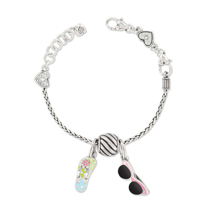 Brighton silver-plated charm bracelet with enamel flip-flop, sunglasses, striped bead, and crystal heart accents on a white background