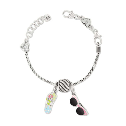 Brighton silver-plated charm bracelet with enamel flip-flop, sunglasses, striped bead, and crystal heart accents on a white background