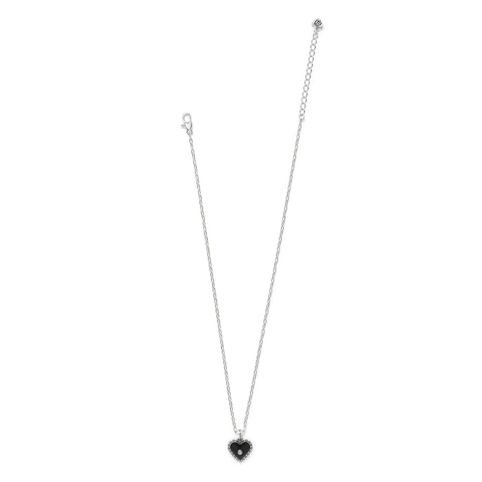 Brighton pendant necklace with silver-plated chain and black enamel heart pendant with crystal center on a white background