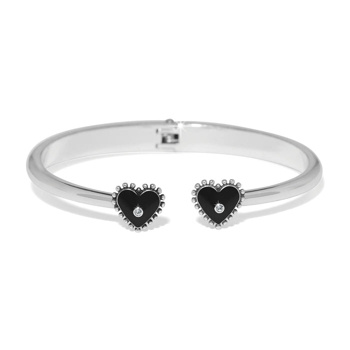 Brighton hinged cuff bracelet with silver-plated finish and black heart end caps with crystal accents on a white background