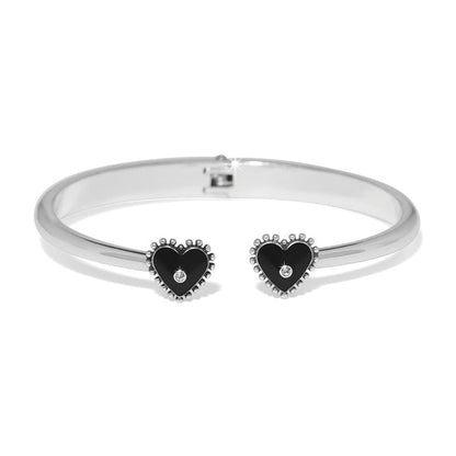 Brighton hinged cuff bracelet with silver-plated finish and black heart end caps with crystal accents on a white background