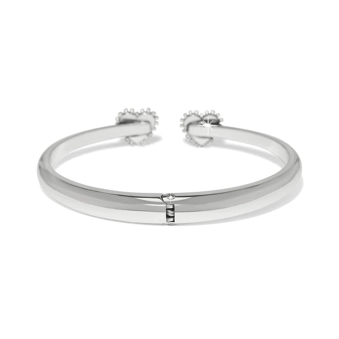 Brighton hinged cuff bracelet with silver-plated finish and two heart-shaped beaded end caps on a white background