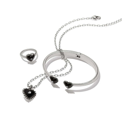 Brighton silver-plated jewelry set with black enamel heart pendant necklace, bangle, and ring with crystal accents on a white background